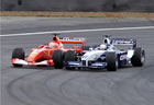 Michael Schumacher(Ferrari) and Juan Pablo Montoya(Williams) / Montoya overtaking Schuey in early stages of the race 2